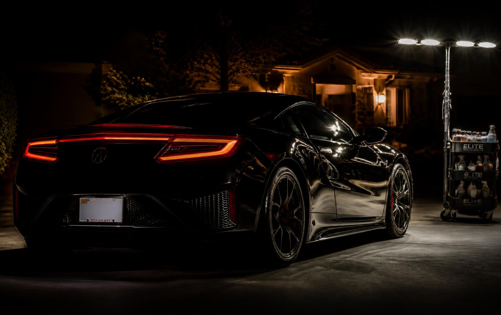 Ceramic coated black sports car detailed in a Chatsworth driveway at night